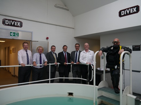 Man standing in diving gear at acquisition of Divex